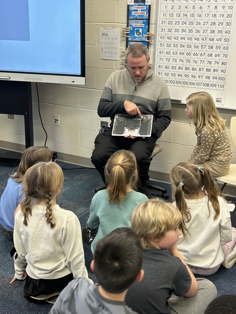 Mr. Morris shows the students what the inside of a computer looks like