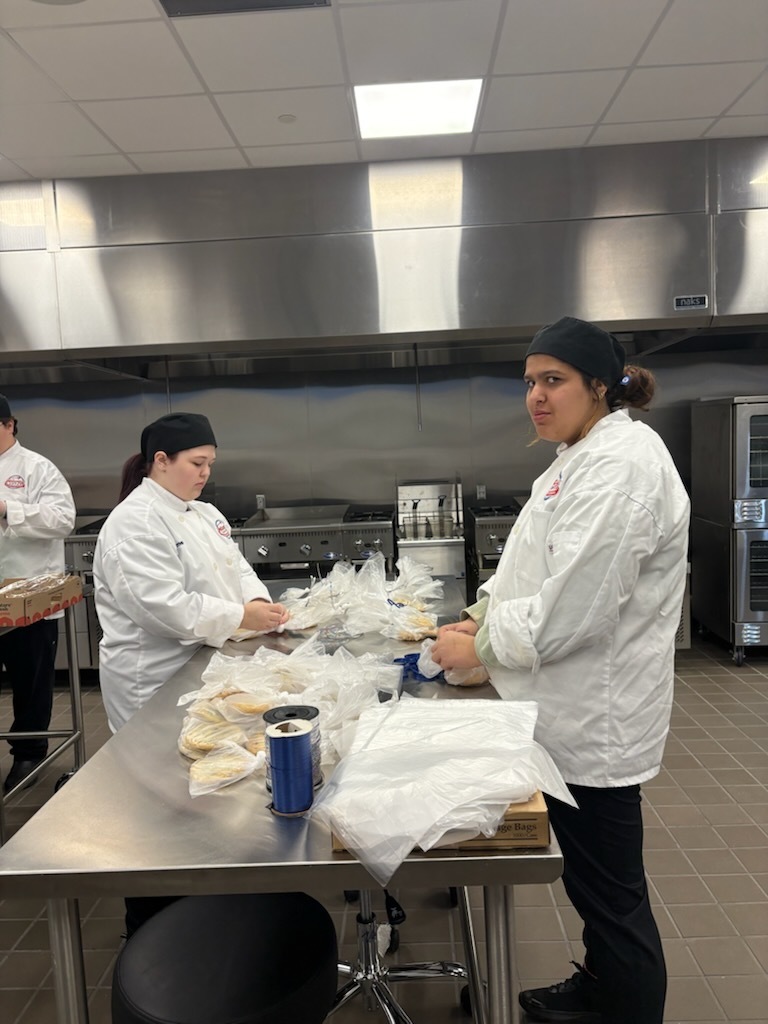 Students putting cookies in bags