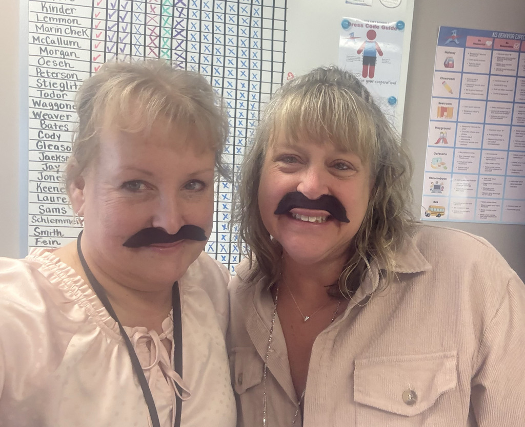 staff members wearing fake mustaches