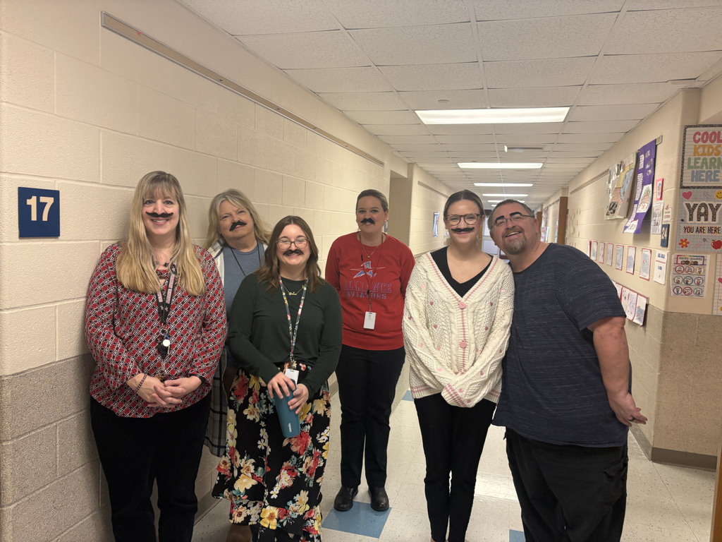 staff members wearing fake mustaches