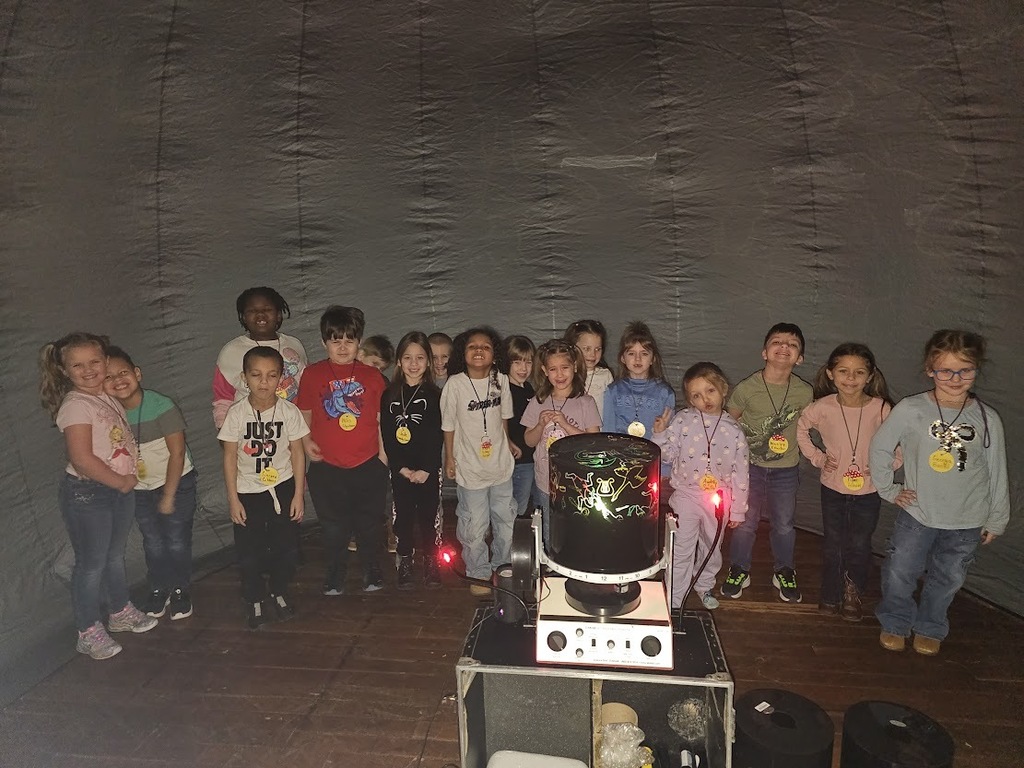 Students smiling while in the star lab