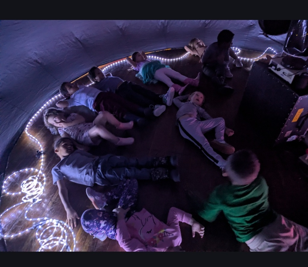 Students looking up at the stars in the star lab