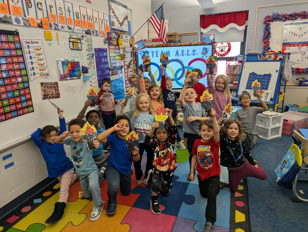 Students holding paper torches they colored