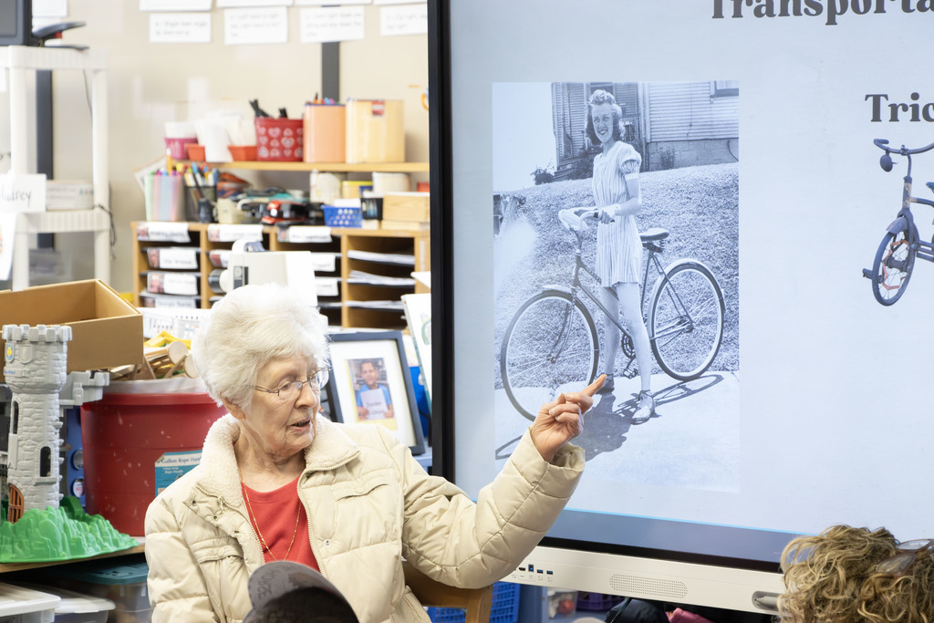 Ms. Haynes pointing at a picture of her when she was a kid riding a bike