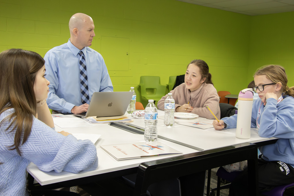 Students talking at a table together