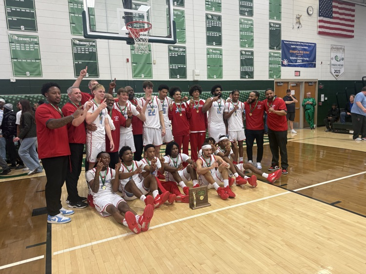 group picture of the alliance boys basketball team after they won the district championship