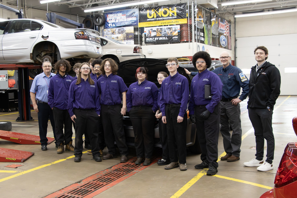 Group picture of the students in front of the van