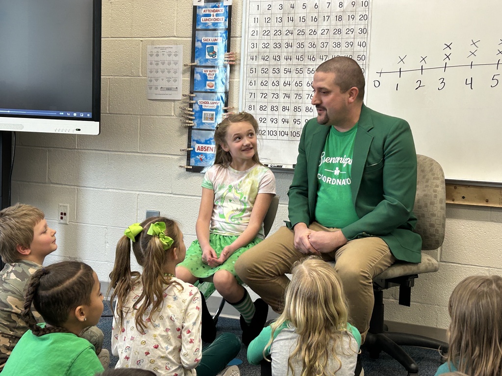 Addalyn looks at her dad as he talks to students
