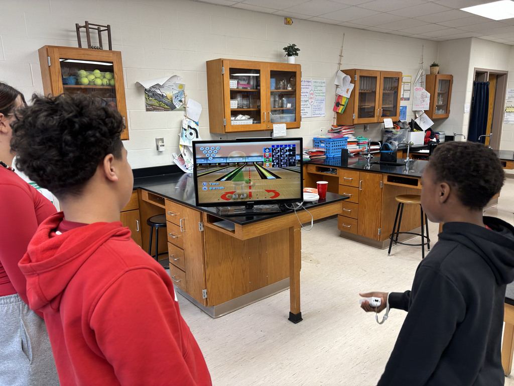 Three students playing wii bowling