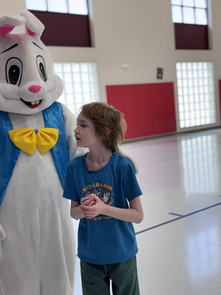 students smiling while next to the easter bunny