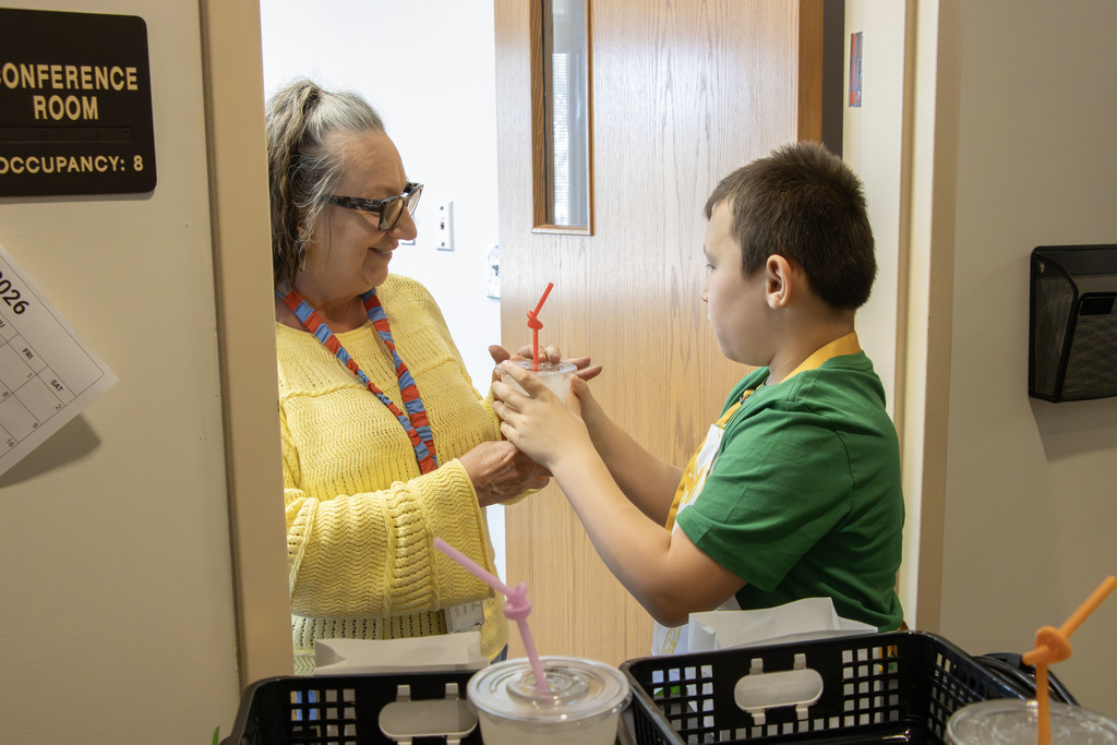 Students delivering lemonade to teachers and staff at AES