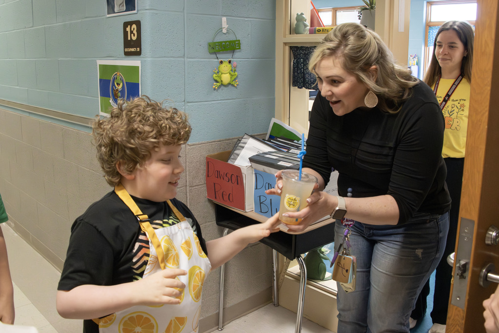Students delivering lemonade to teachers and staff at AES
