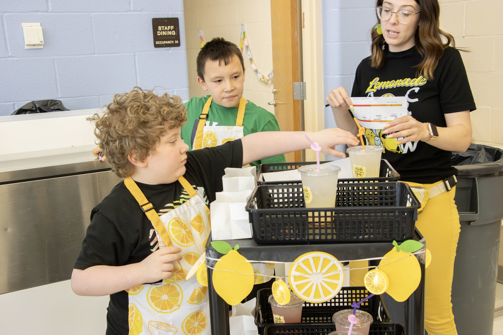 Students delivering lemonade to teachers and staff at AES