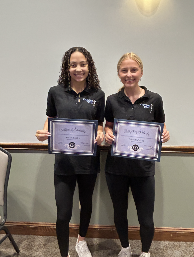 Two students holding certificates