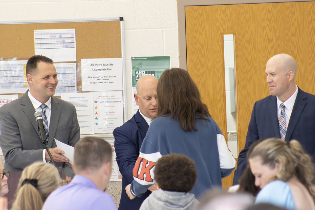 Student shaking hands while getting a certificate