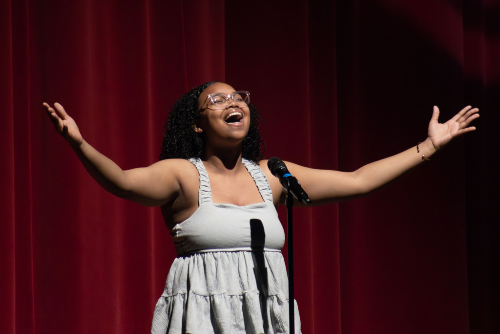 A student singing on stage