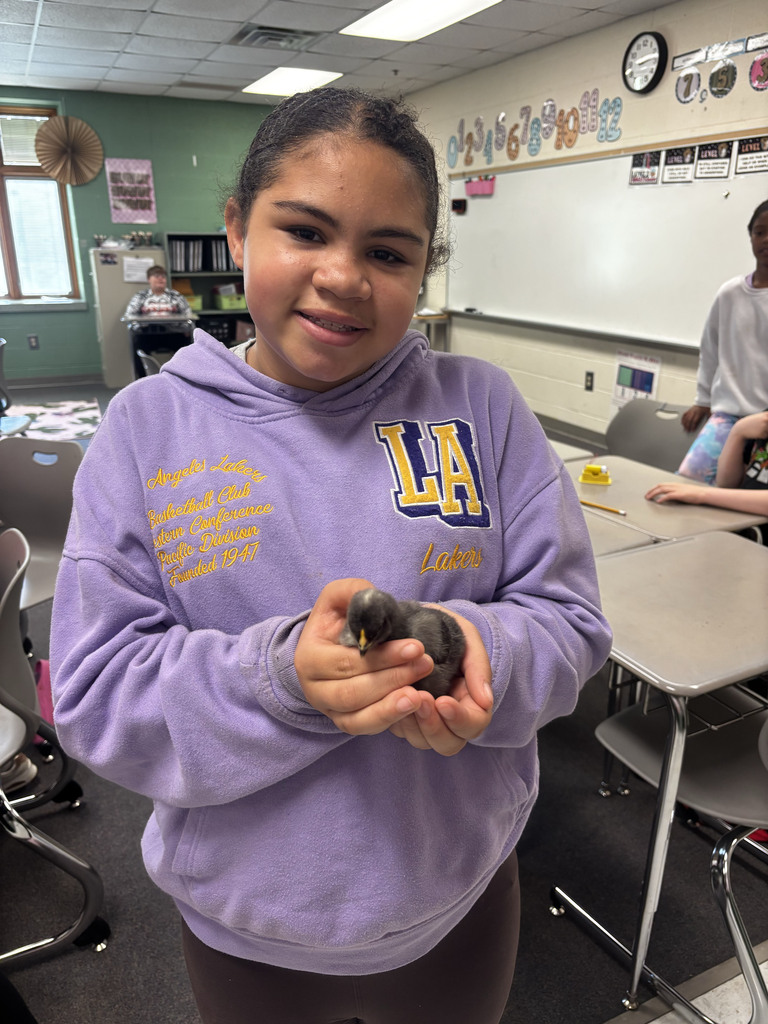 Student holding a baby chick