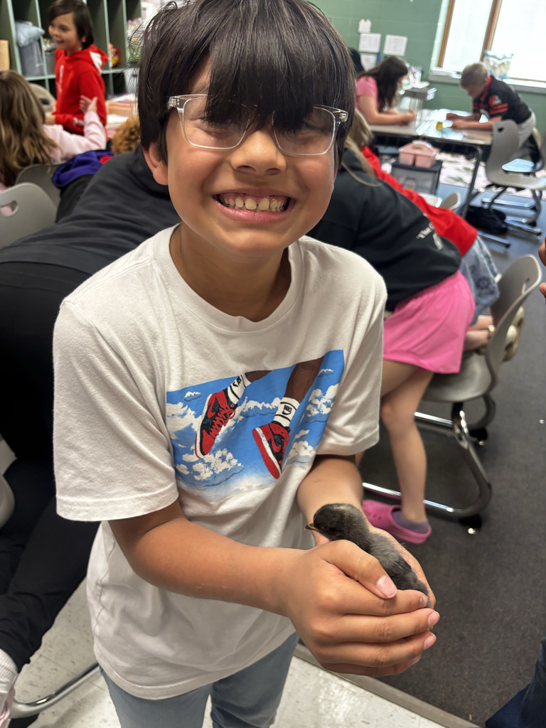Student holding a baby chick