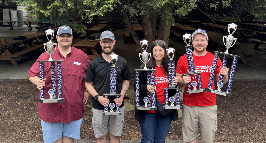 Picture of the Dr. Charles Page, Nick Desjardins, Heather Shive and Nathan Fete holding trophies