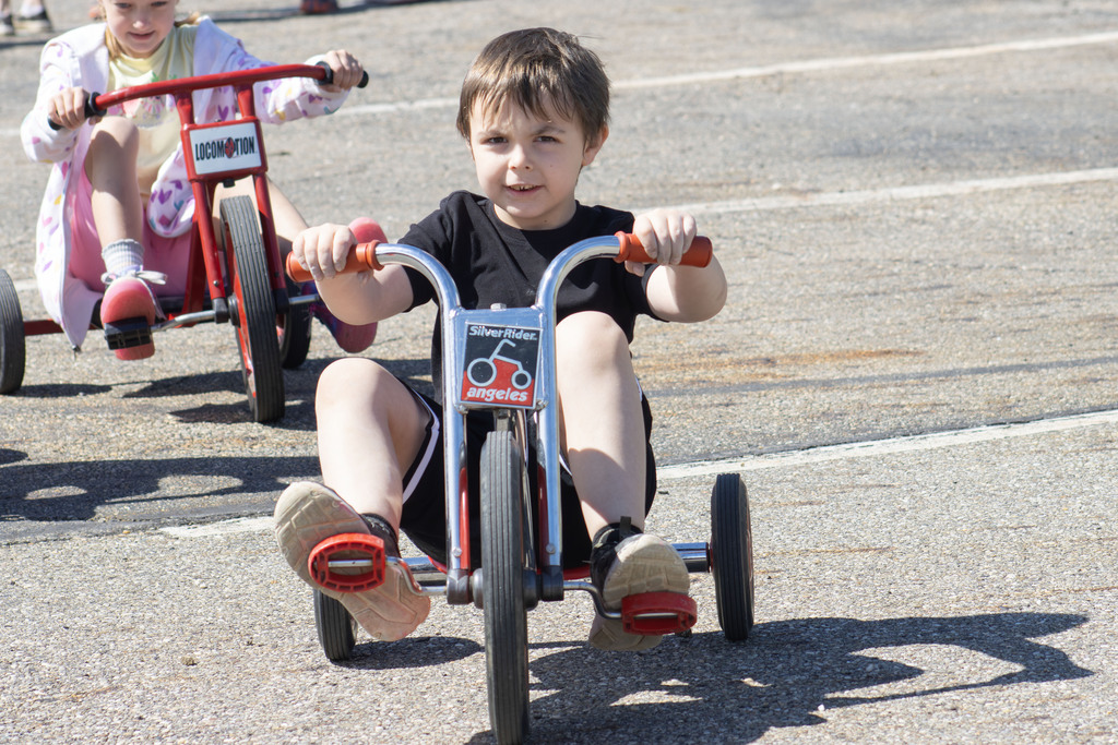 student riding a tricycle