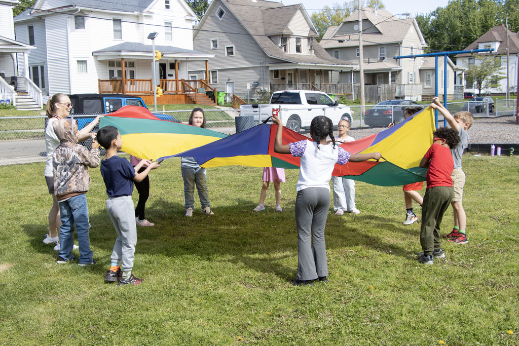 group of students playing with the parachute