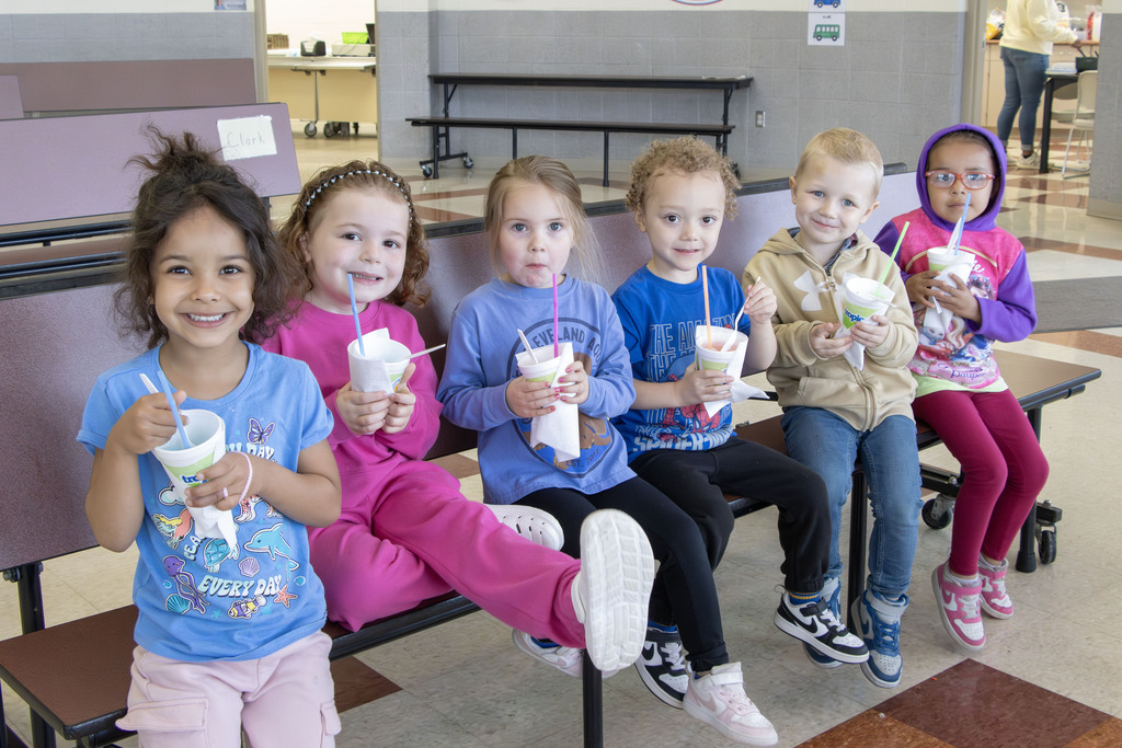 students smiling while eating snow cones
