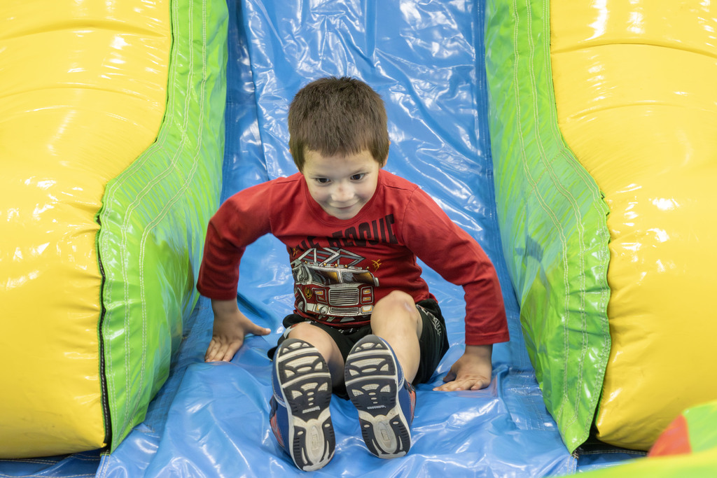 student sliding down a giant slide