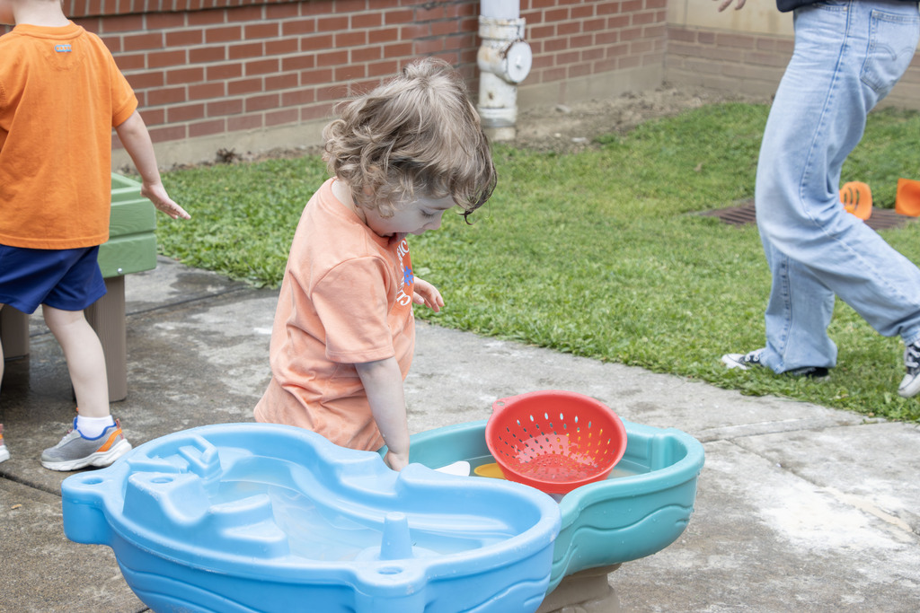 student playing at a water sensory table