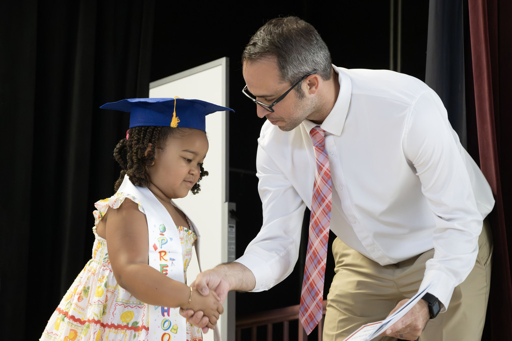 principal shaking hands with one of the students