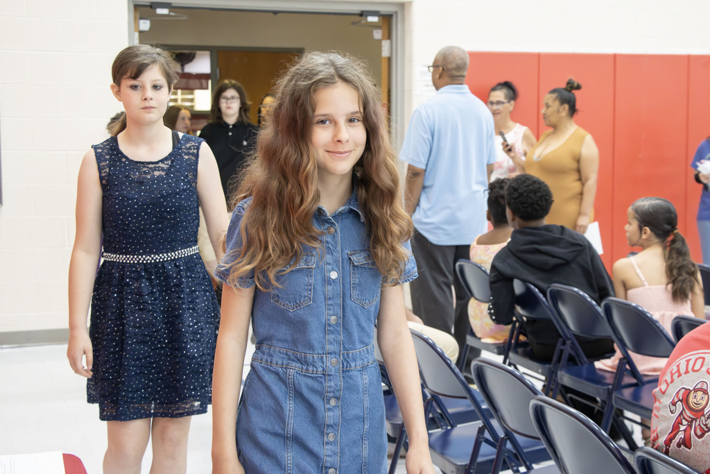 Student smiling as she walks in the processional