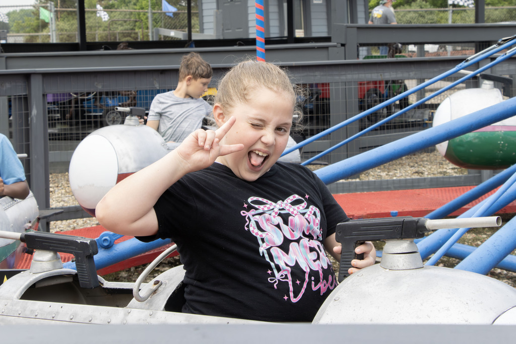 student riding on a carnival ride