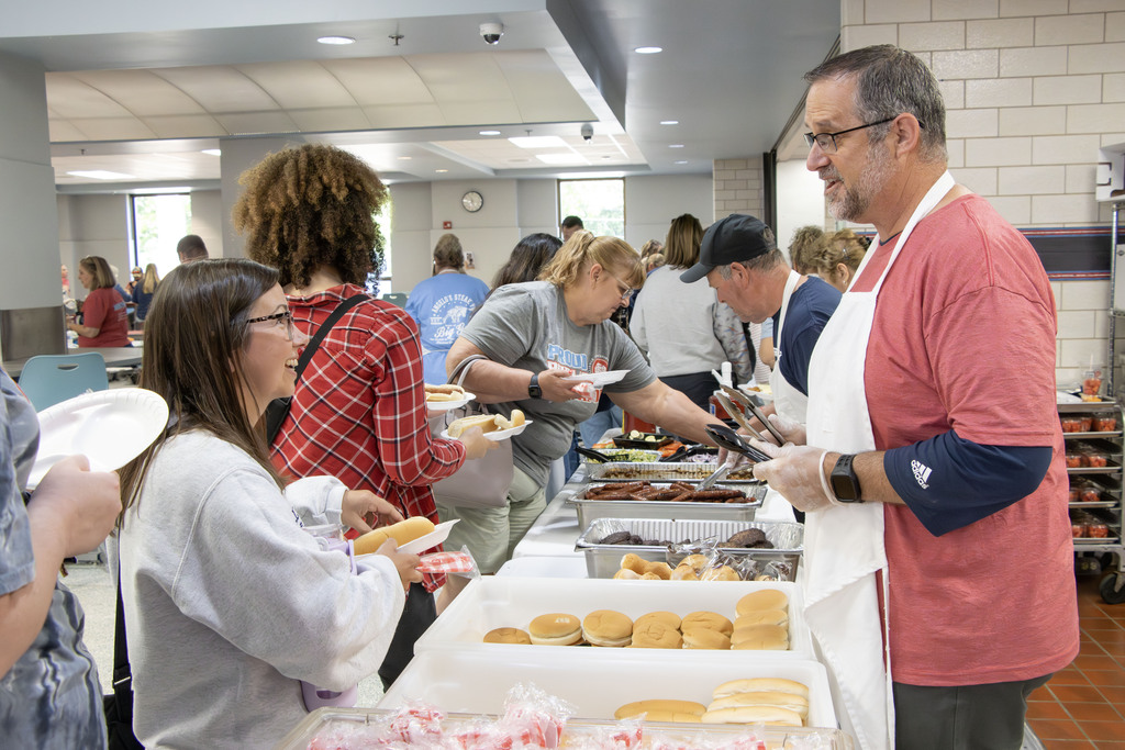 Superintendent Gress helping to serve food at the staff cookout
