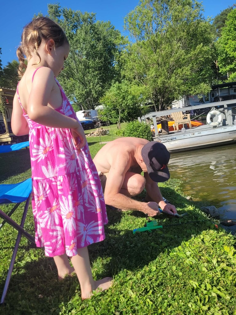 bailey catching a fish with her dad