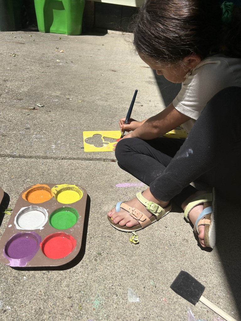 Raegan painting her driveway