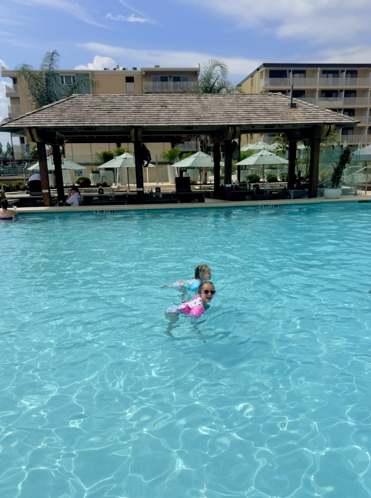 Kenzley and her little sister swimming in a pool