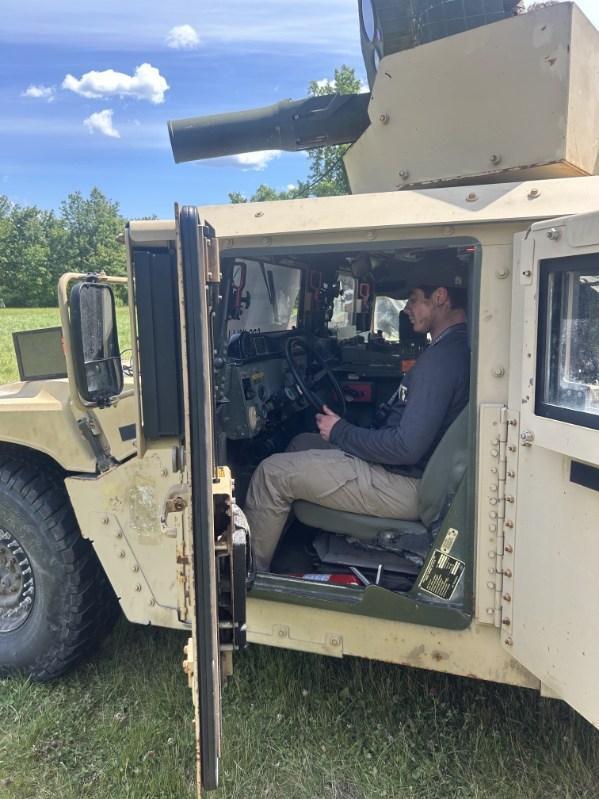 Trent sitting in a military vehicle.