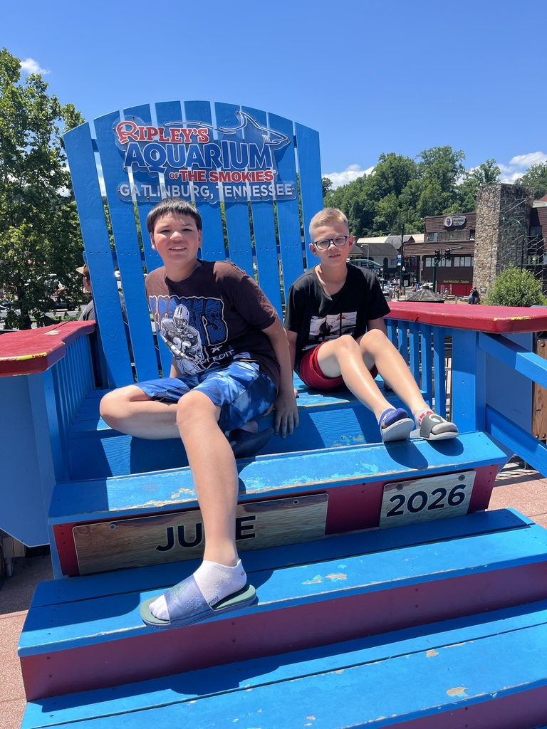 Jaydan and Chris sitting on a giant beach chair