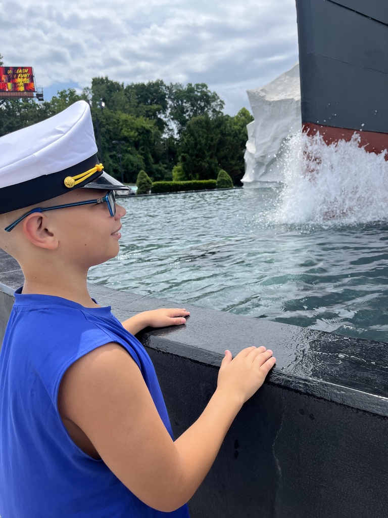 Chris staring at water with a replica of the Titanic