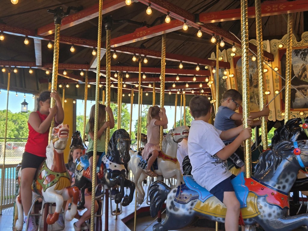 the three student riding a carousel