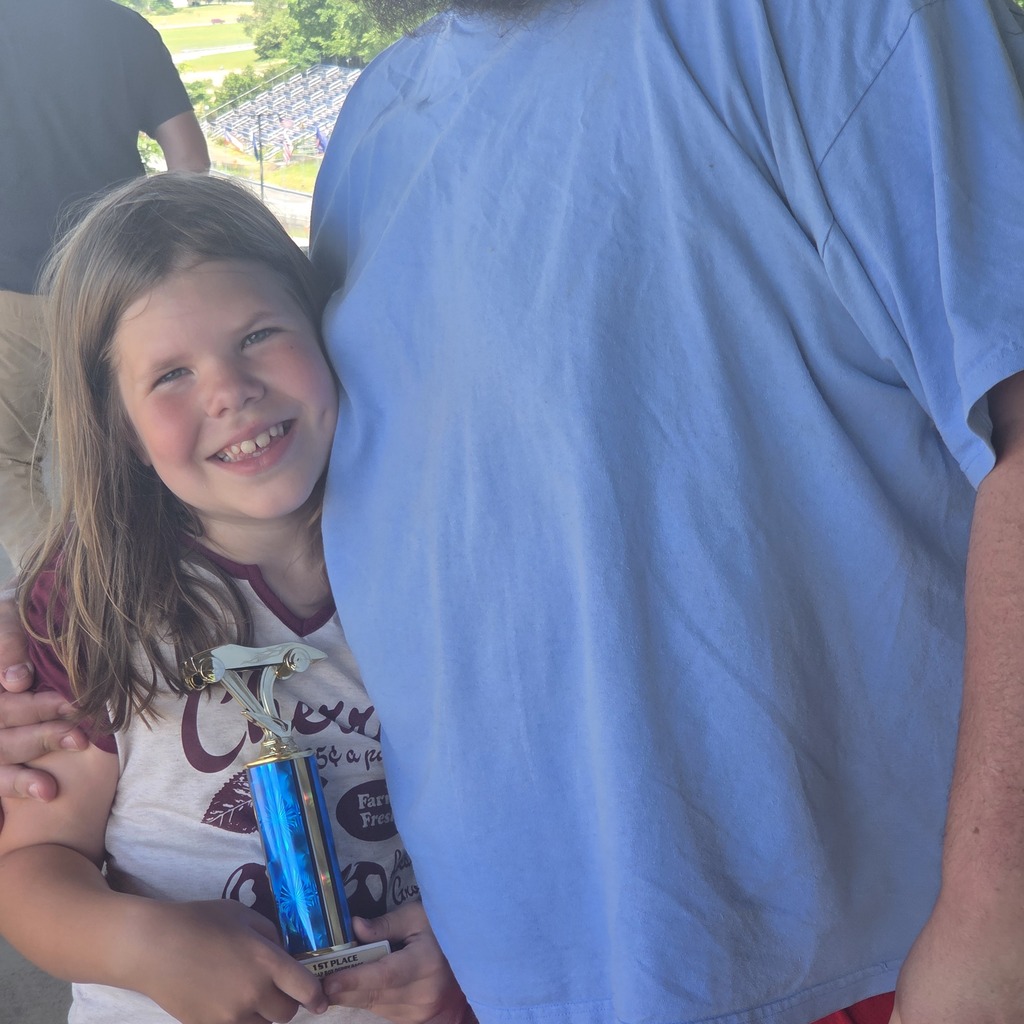 Gwen holding her soap box derby trophy