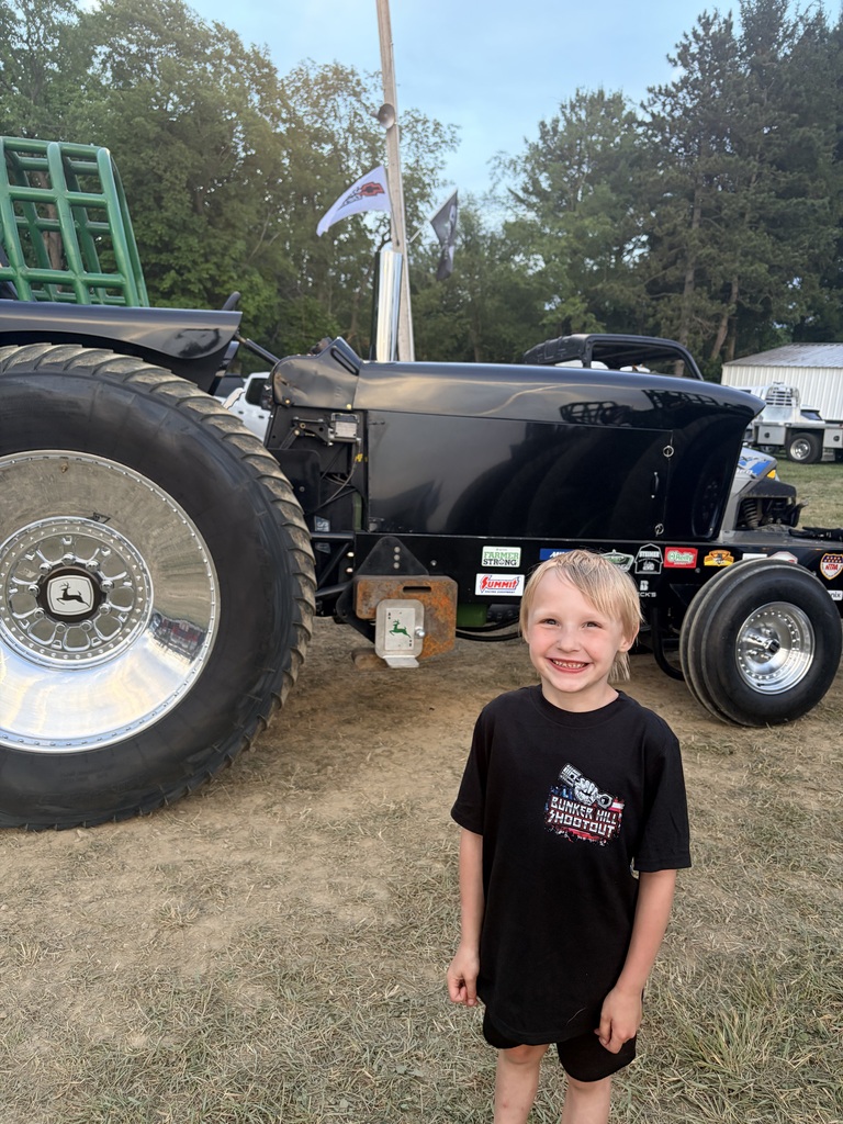 Jameson standing in front of a tractor