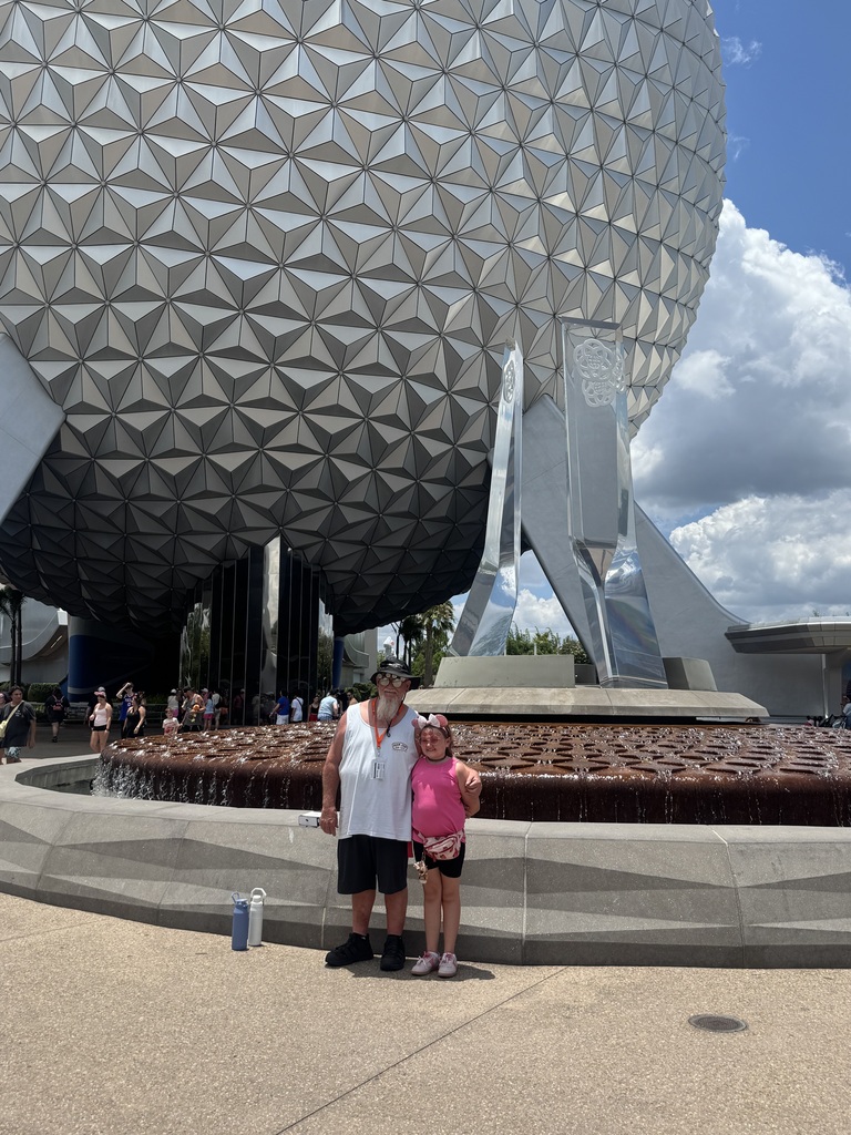 Julie standing with her family at Epcot