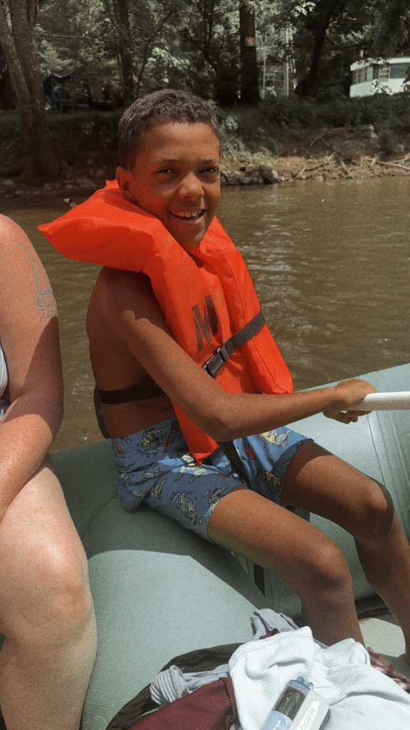a student smiling while wearing a life jacket 