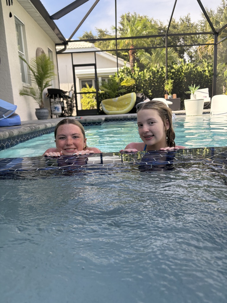 Aylamae and Catey swimming in a pool