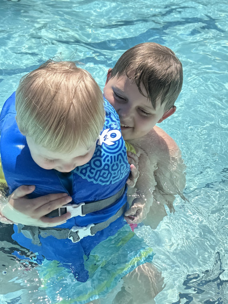 Mark swimming with his younger brother