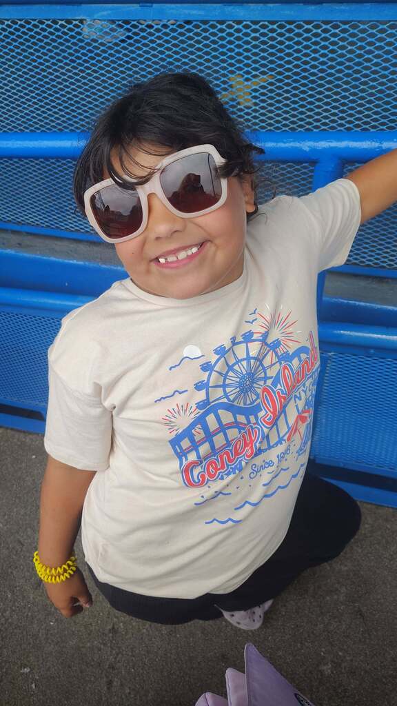 Ava smiling with sunglasses on