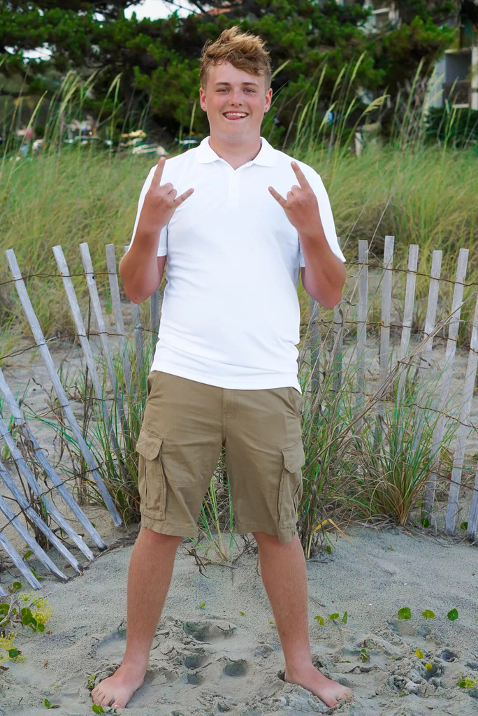 A student smiling on the beach