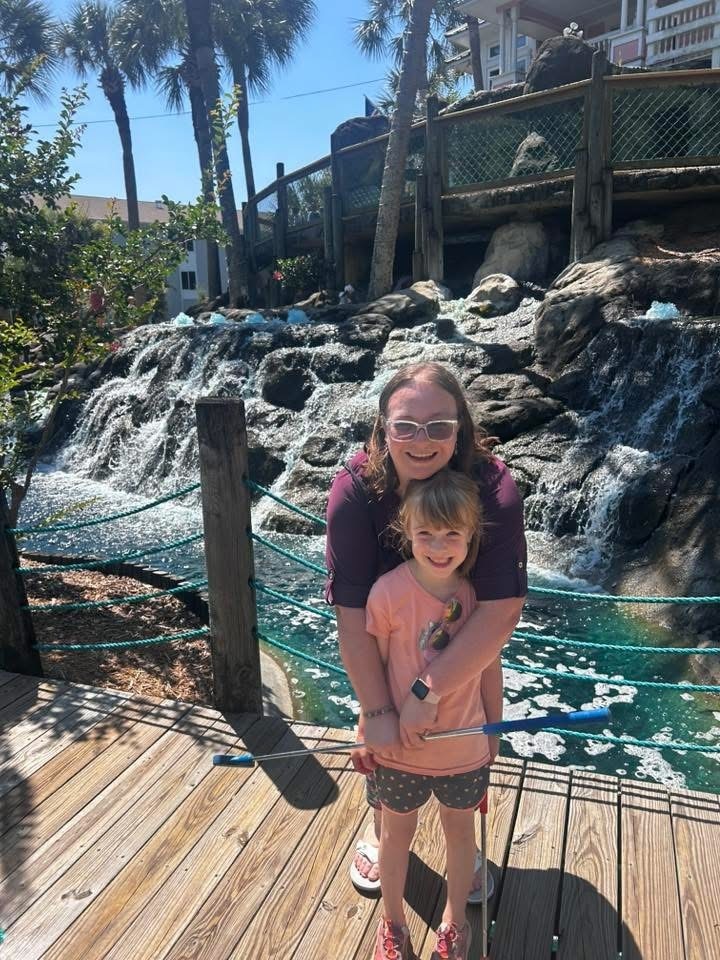 Ellie and Mrs. Winland standing together on a dock