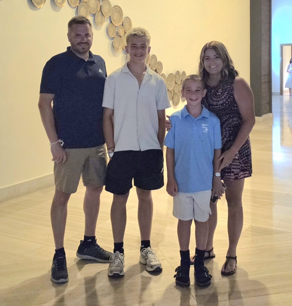 The Adams family standing for a picture