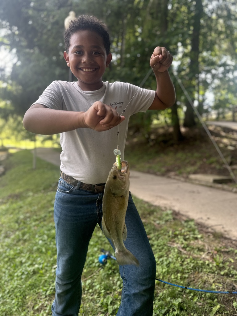 Liam holding a bass he caught at Silver Park
